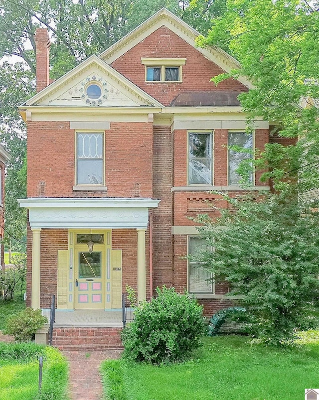 326 N 9th, Paducah, KY 42001 - view of front of property featuring brick siding, a chimney, and covered porch