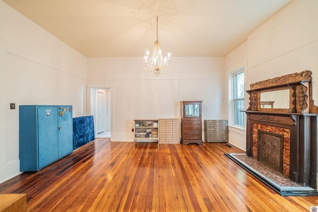 326 N 9th, Paducah, KY 42001 - living room featuring wood-type flooring, a chandelier, and a brick fireplace