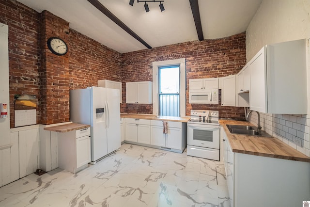 326 N 9th, Paducah, KY 42001 - kitchen featuring butcher block counters, white appliances, brick wall, decorative backsplash, and light marble finish flooring