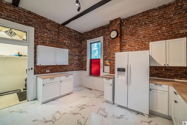 326 N 9th, Paducah, KY 42001 - kitchen featuring white refrigerator with ice dispenser, light marble finish floors, butcher block countertops, brick wall, and white cabinetry