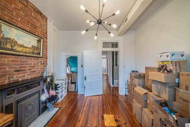 326 N 9th, Paducah, KY 42001 - living room featuring a chandelier, hardwood / wood-style floors, and brick wall