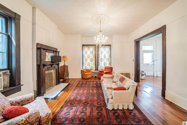 326 N 9th, Paducah, KY 42001 - living area with wood finished floors, a chandelier, and a fireplace with raised hearth