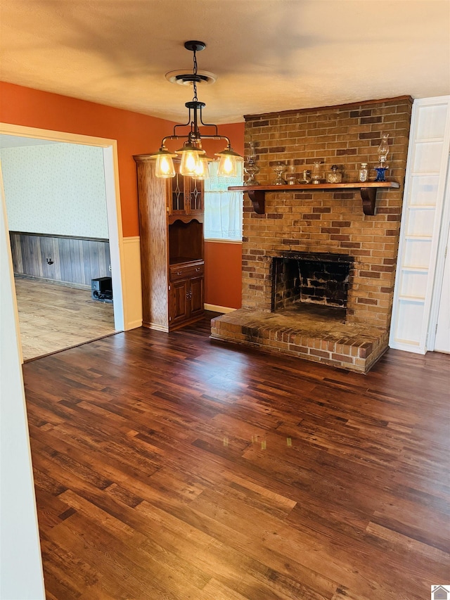 111 Cherry Grove Dr, Benton, KY 42025 - unfurnished living room featuring wainscoting, wood finished floors, a fireplace, and wallpapered walls