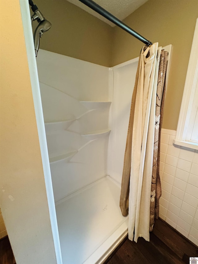 111 Cherry Grove Dr, Benton, KY 42025 - bathroom featuring a shower stall, wood finished floors, tile walls, and wainscoting