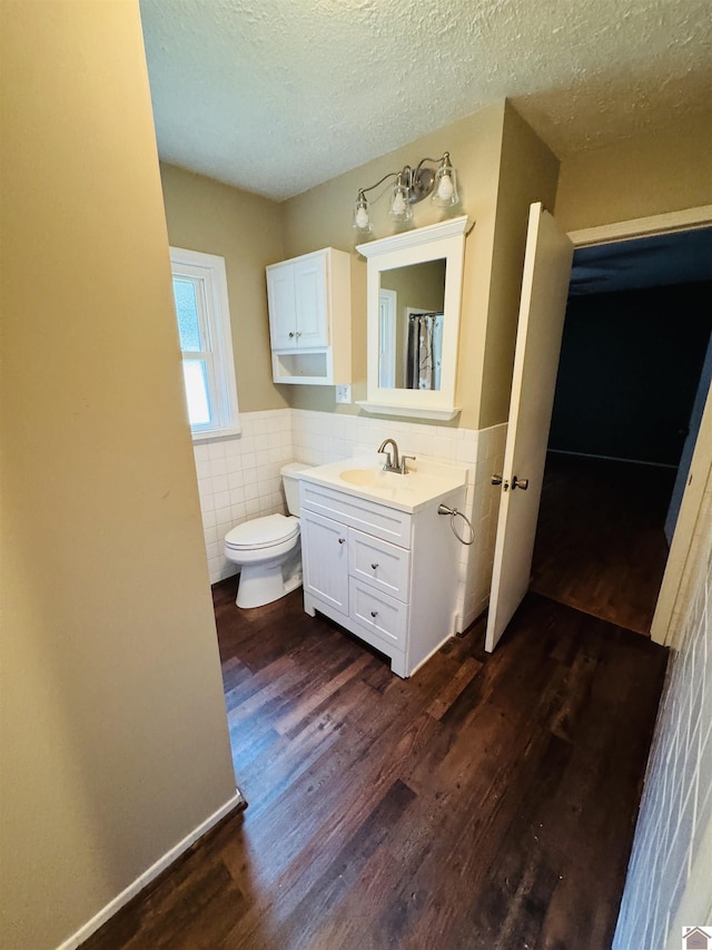 111 Cherry Grove Dr, Benton, KY 42025 - bathroom with tile walls, wood finished floors, vanity, a wainscoted wall, and a textured ceiling
