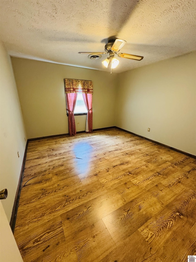 111 Cherry Grove Dr, Benton, KY 42025 - empty room featuring a ceiling fan, light wood-type flooring, and a textured ceiling