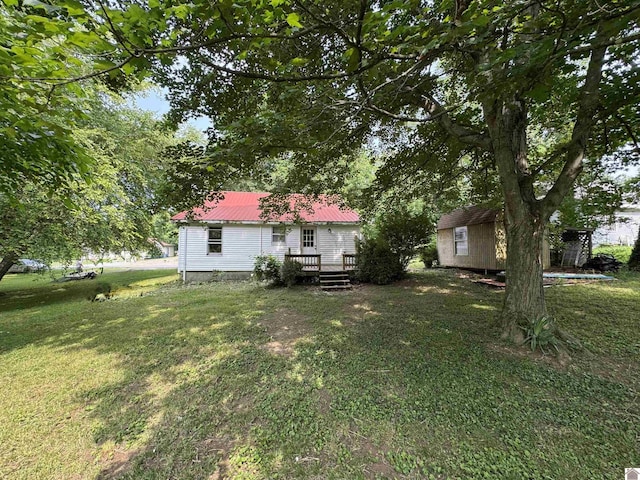 67 Beshear Ln, Princeton, KY 42445 - view of grassy yard with a deck and a shed