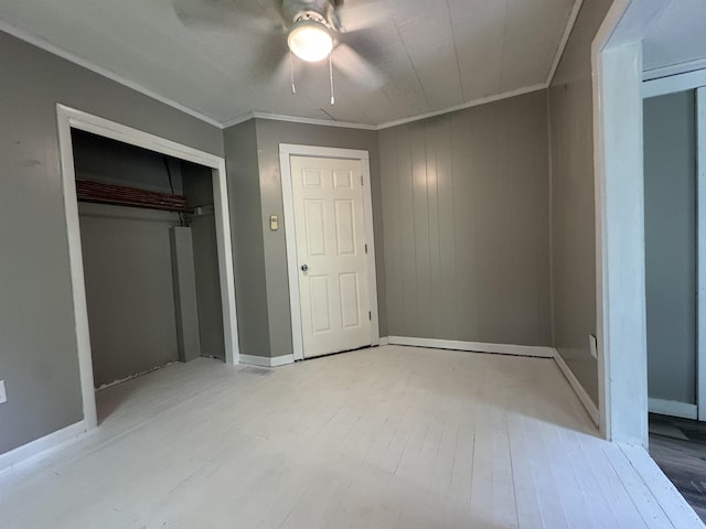 67 Beshear Ln, Princeton, KY 42445 - unfurnished bedroom with wood finished floors, a closet, ceiling fan, crown molding, and wooden walls