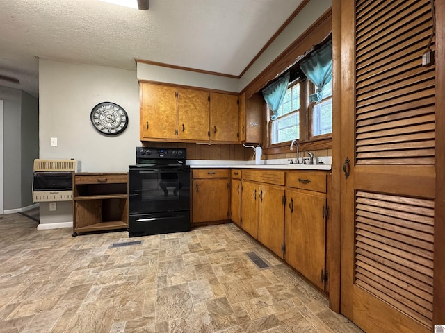67 Beshear Ln, Princeton, KY 42445 - kitchen featuring black range with electric stovetop, heating unit, light countertops, light stone finish flooring, and brown cabinets