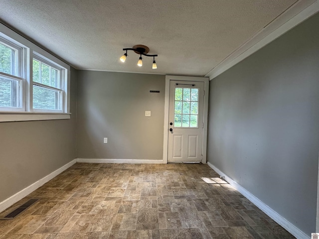 67 Beshear Ln, Princeton, KY 42445 - entryway with a textured ceiling, stone finish floors, and crown molding