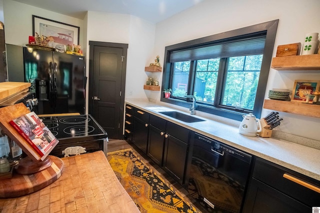 3431 Irvin Cobb Rd, Murray, KY 42071 - kitchen featuring black appliances, dark cabinetry, wood counters, open shelves, and wood finished floors