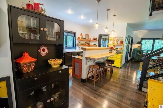 3431 Irvin Cobb Rd, Murray, KY 42071 - kitchen featuring butcher block countertops, plenty of natural light, dark wood-style floors, a kitchen bar, and recessed lighting