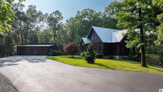 3431 Irvin Cobb Rd, Murray, KY 42071 - view of front of home featuring an outdoor structure, a metal roof, a front yard, and driveway