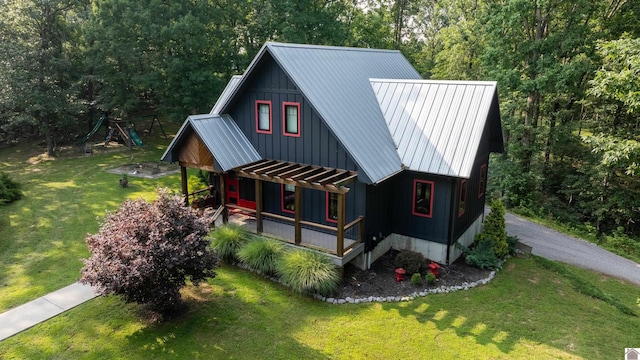 3431 Irvin Cobb Rd, Murray, KY 42071 - view of front of home with a porch, board and batten siding, a front lawn, and a metal roof