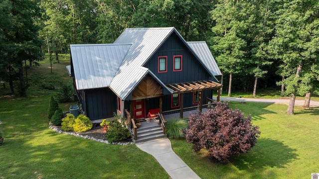 3431 Irvin Cobb Rd, Murray, KY 42071 - view of front of house featuring a porch, a front lawn, a metal roof, and a wooded view