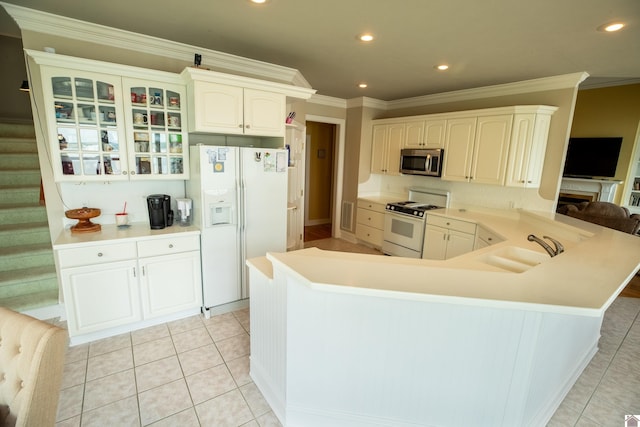 129 Wayne Cir, New Concord, KY 42076 - kitchen with white appliances, a peninsula, glass insert cabinets, light tile patterned floors, and ornamental molding