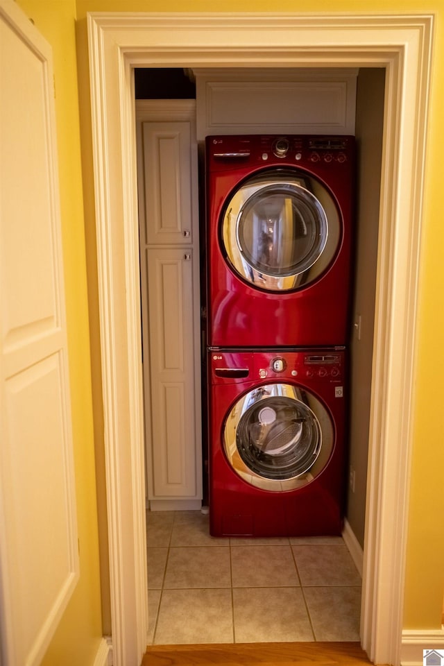 129 Wayne Cir, New Concord, KY 42076 - laundry area featuring stacked washer / dryer and light tile patterned floors