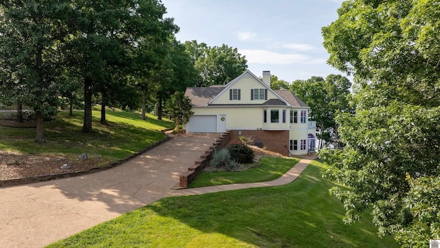 129 Wayne Cir, New Concord, KY 42076 - view of property exterior featuring a chimney, a yard, a garage, and brick siding