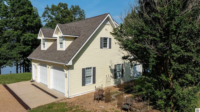 129 Wayne Cir, New Concord, KY 42076 - view of side of property featuring a garage, driveway, and a shingled roof