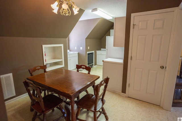 129 Wayne Cir, New Concord, KY 42076 - dining area with built in shelves, lofted ceiling, and a chandelier