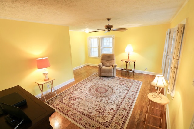 2567 Clay St, Paducah, KY 42001 - living area featuring a textured ceiling, ceiling fan, and wood finished floors