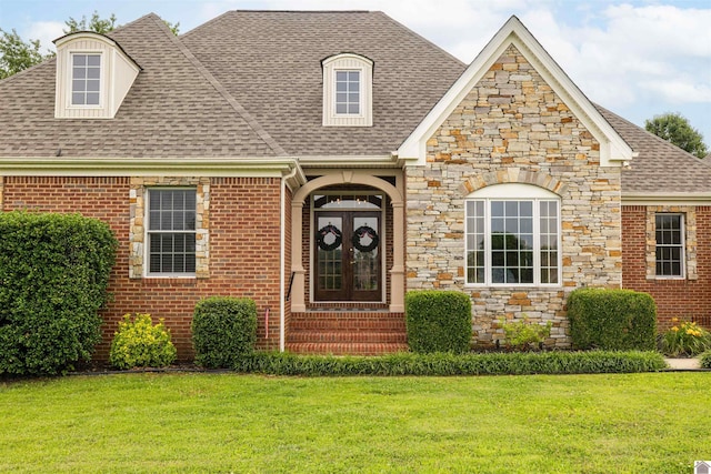 130 Camden Way, Paducah, KY 42001 - view of front of house with roof with shingles, stone siding, a front yard, entry steps, and brick siding