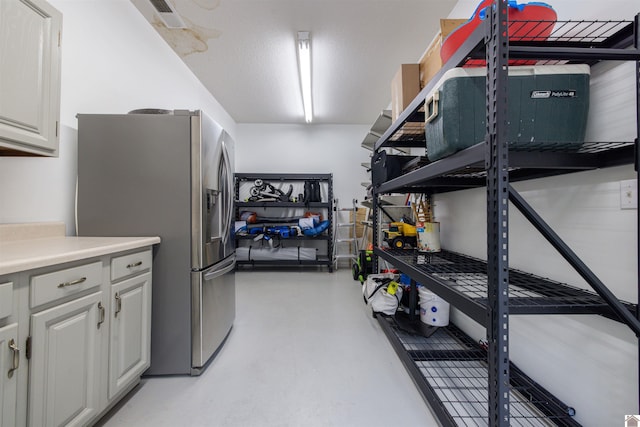 130 Camden Way, Paducah, KY 42001 - kitchen with stainless steel fridge with ice dispenser, concrete floors, white cabinetry, and light countertops