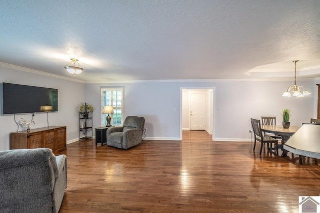 1530 Holt Rd, Paducah, KY 42001 - living area featuring wood finished floors, a textured ceiling, a chandelier, and crown molding