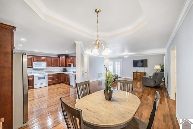 1530 Holt Rd, Paducah, KY 42001 - dining area featuring light wood finished floors, a tray ceiling, a chandelier, recessed lighting, and crown molding