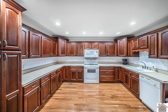1530 Holt Rd, Paducah, KY 42001 - kitchen featuring white appliances, light countertops, light wood-style flooring, recessed lighting, and dark brown cabinets
