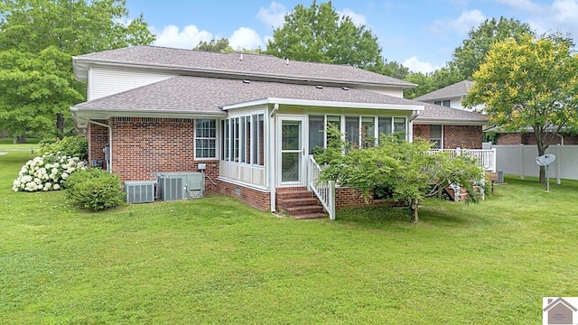 1530 Holt Rd, Paducah, KY 42001 - back of property with brick siding, a sunroom, and a shingled roof