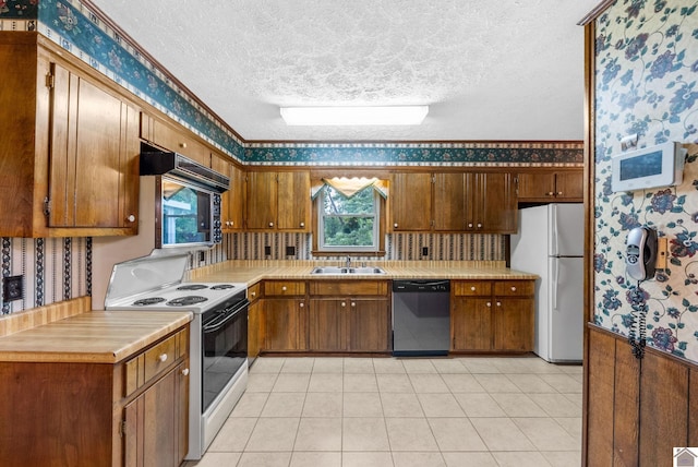 301 Tremont Dr, Hopkinsville, KY 42240 - kitchen featuring white appliances, wallpapered walls, a textured ceiling, light countertops, and plenty of natural light