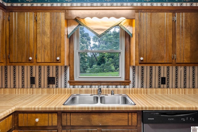 301 Tremont Dr, Hopkinsville, KY 42240 - kitchen with dishwasher, light countertops, and brown cabinets