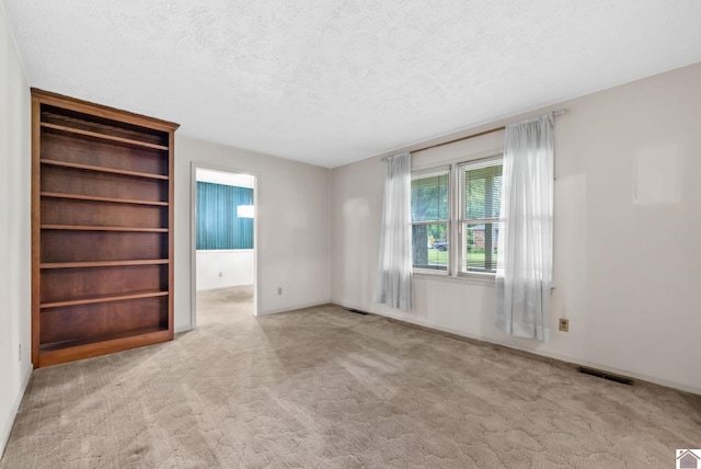 301 Tremont Dr, Hopkinsville, KY 42240 - spare room featuring carpet and a textured ceiling
