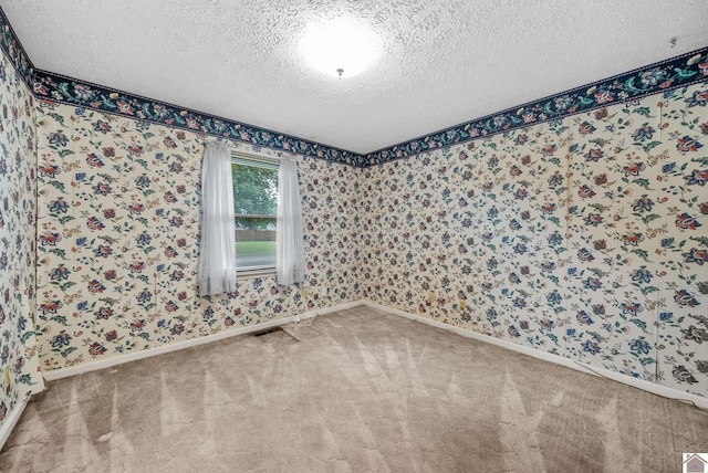 301 Tremont Dr, Hopkinsville, KY 42240 - unfurnished room with carpet flooring, a textured ceiling, and wallpapered walls