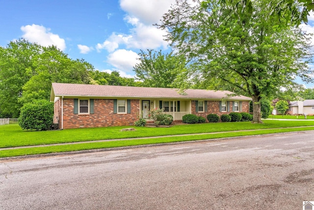 301 Tremont Dr, Hopkinsville, KY 42240 - ranch-style house featuring brick siding, a front lawn, and covered porch