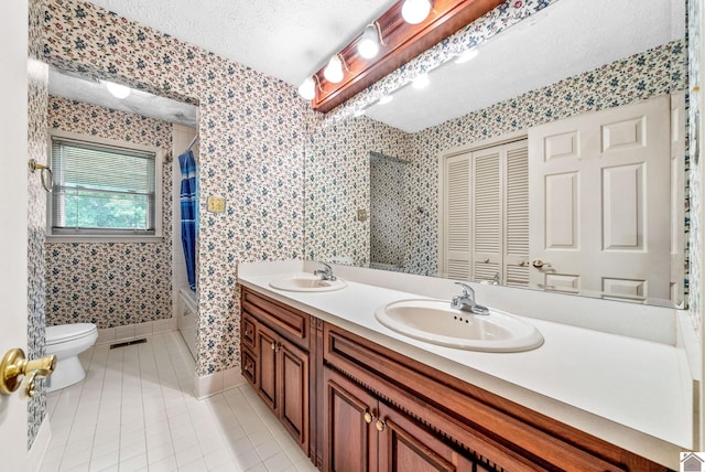 301 Tremont Dr, Hopkinsville, KY 42240 - bathroom with a textured ceiling, tile patterned flooring, shower / bath combo, and double vanity