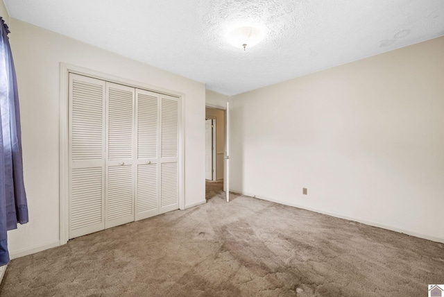 301 Tremont Dr, Hopkinsville, KY 42240 - unfurnished bedroom featuring carpet, a closet, and a textured ceiling