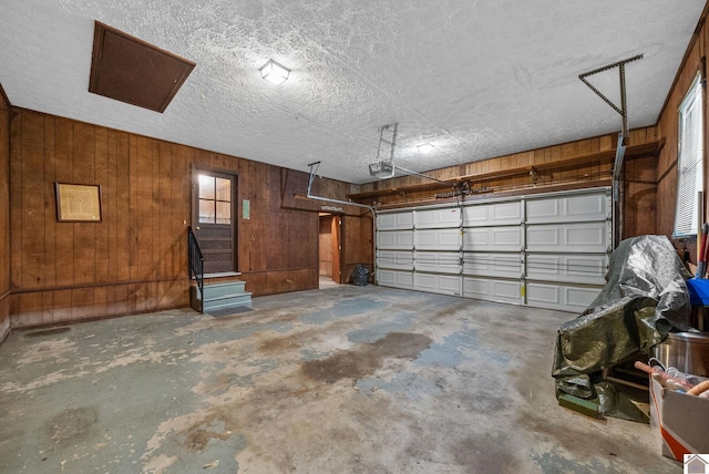 301 Tremont Dr, Hopkinsville, KY 42240 - garage featuring a garage door opener and wood walls