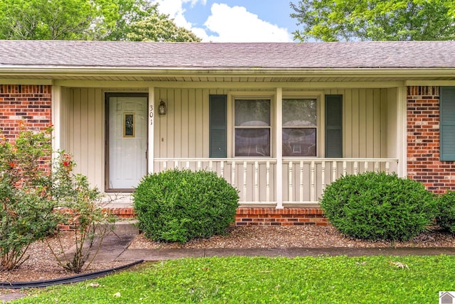 301 Tremont Dr, Hopkinsville, KY 42240 - view of exterior entry featuring brick siding, covered porch, and a shingled roof