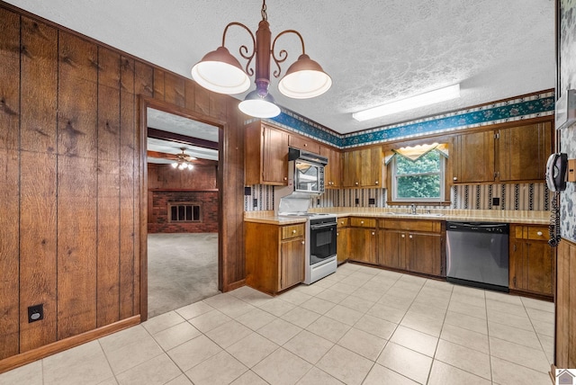 301 Tremont Dr, Hopkinsville, KY 42240 - kitchen featuring stainless steel dishwasher, range with electric stovetop, light countertops, a textured ceiling, and brown cabinets
