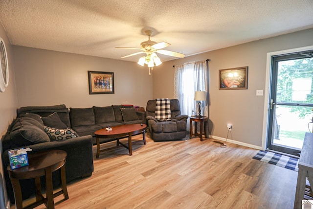 1040 Weda Cir, Mayfield, KY 42066 - living area featuring light wood finished floors, plenty of natural light, ceiling fan, and a textured ceiling