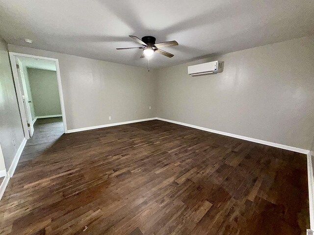 403 N 19th St, Paducah, KY 42001 - spare room featuring a wall unit AC, a ceiling fan, dark wood-type flooring, and a smoke detector