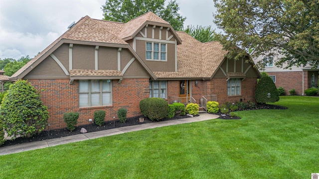 1201 Winslow Way, Paducah, KY 42001 - tudor home with stucco siding, a front yard, brick siding, and roof with shingles