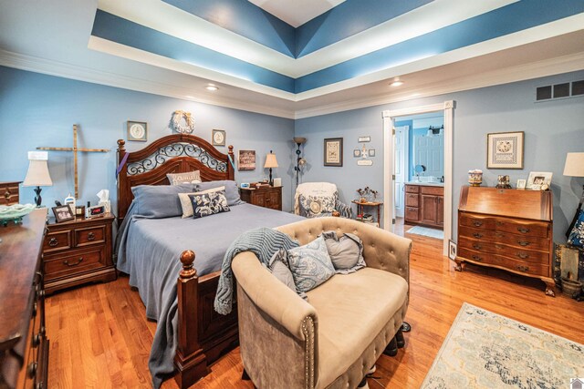 1201 Winslow Way, Paducah, KY 42001 - bedroom featuring ornamental molding, light wood-style floors, a raised ceiling, recessed lighting, and connected bathroom