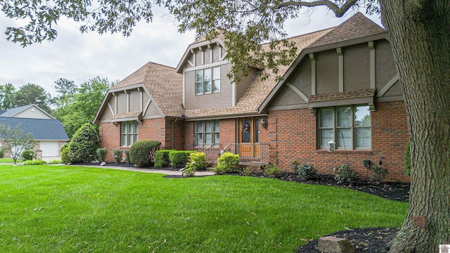 1201 Winslow Way, Paducah, KY 42001 - tudor home with a front yard, brick siding, roof with shingles, and stucco siding