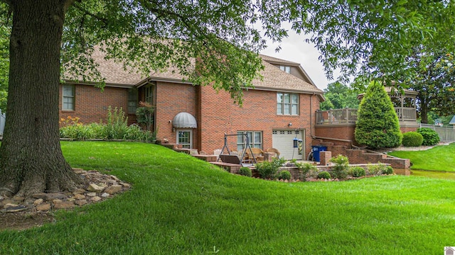1201 Winslow Way, Paducah, KY 42001 - back of house with brick siding, a garage, a lawn, roof with shingles, and a deck