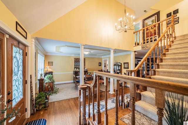 1201 Winslow Way, Paducah, KY 42001 - entryway featuring ornate columns, crown molding, a chandelier, high vaulted ceiling, and stairs