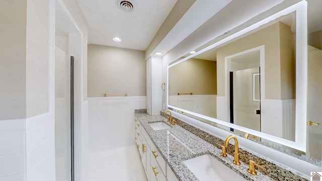 700 S 16th, Murray, KY 42071 - bathroom featuring double vanity, a wainscoted wall, tile walls, and recessed lighting