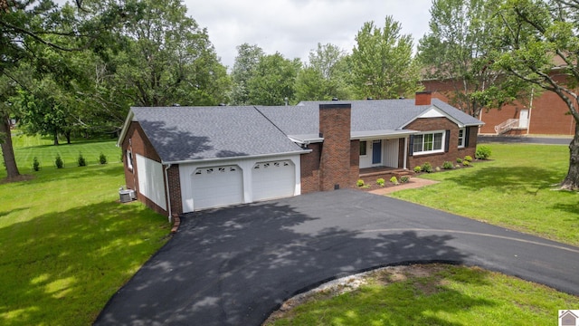700 S 16th, Murray, KY 42071 - ranch-style house featuring brick siding, a chimney, a front lawn, an attached garage, and asphalt driveway